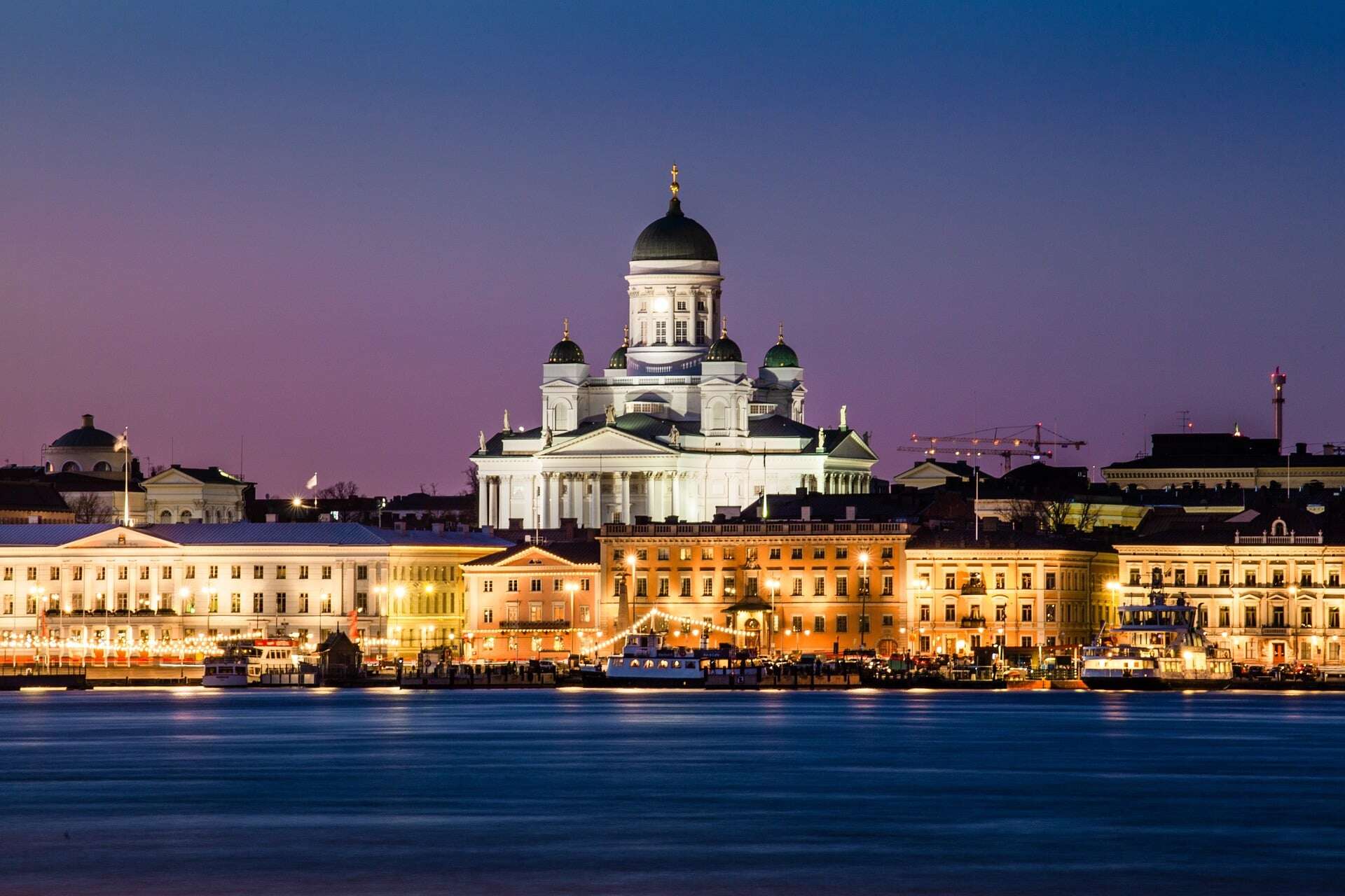 Helsinki Cathedral shown among other city buildings at night